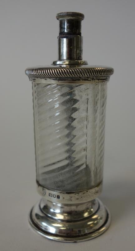 English Sterling Silver Pepper Mill: English sterling silver and swirled glass pepper mill. Hallmarks for London 1910, Arthur Martin Parsons & Frank Herbert Parsons. Measures 4" tall.