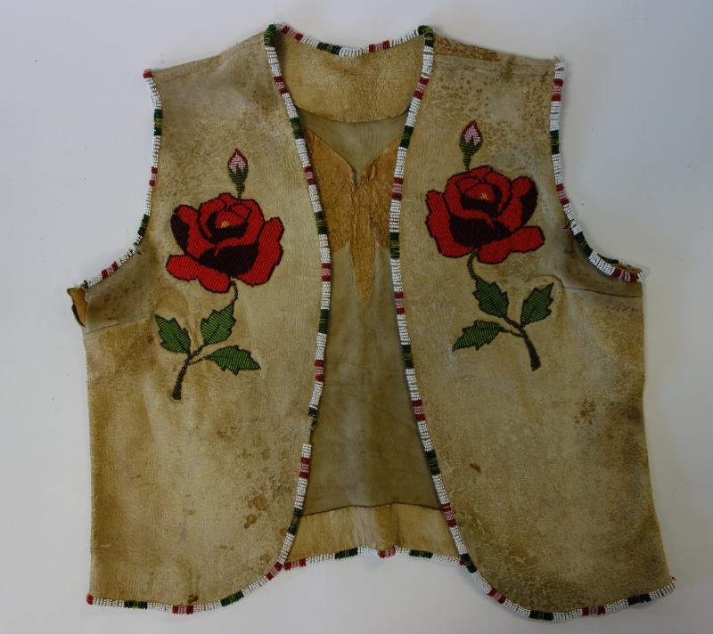 Native American Suede Beaded Vest: Native American suede vest. Adorned with beaded roses on the front. The reverse with a beaded butterfly.