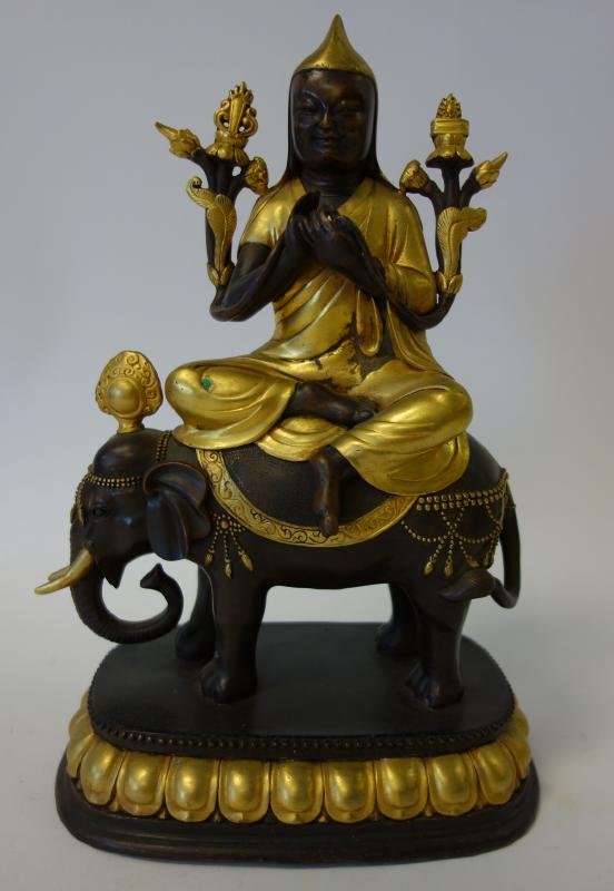Hindu Bronze Male Riding Elephant: Hindu gilt bronze figural group depicting a cross legged male riding an elephant. Nepal, late 19th/early 20th century. Measures 11" high and 8" x 5.5" at the base.