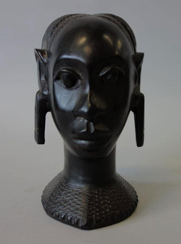 Carved African Ebony Wood Female Eket Head: African eket head. Finely carved depicting a female. Measures 7" high.