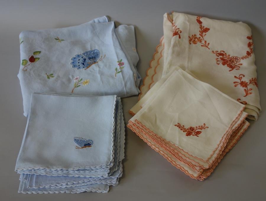 Embroidered Linen Summer Napkins & Tablecloths: 2 sets of embroidered linen napkins and matching tablecloths. Comprised of 14 blue napkins embroidered with butterflies measuring 17" x 18" and a similar matching oval tablecloth with floral and butte