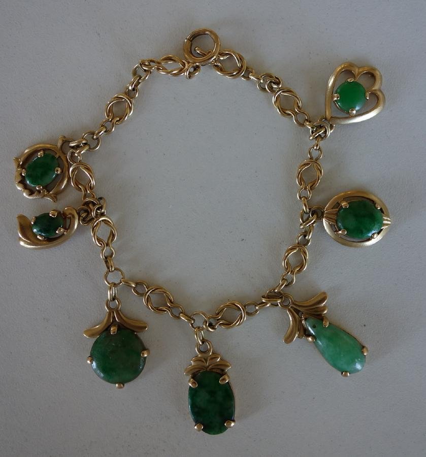 Chinese Jadeite Jade & 14K Gold Bracelet: A Chinese Jadeite Jade & 14K gold bracelet. 7 jade cabochons of various sizes and shapes set in a 14K gold chain bracelet. Measures 7" long. Overall weight 17.4 grams.