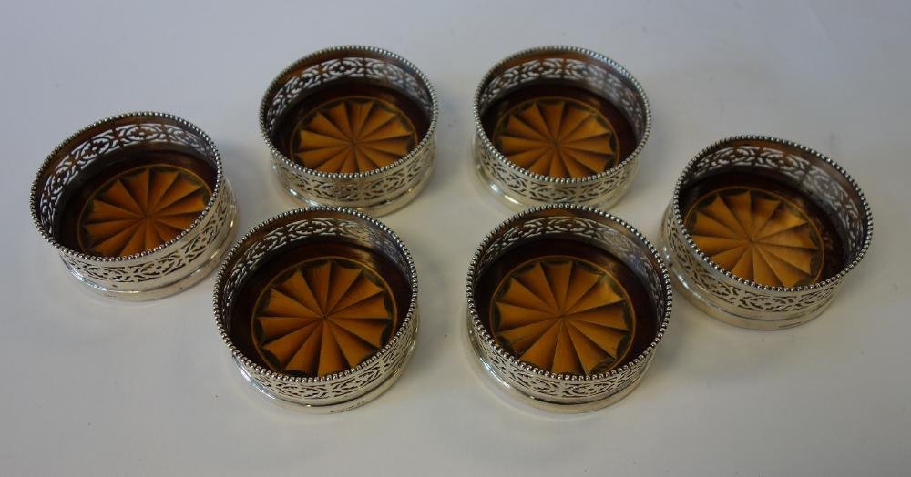 6 Goodnow & Jenks Sterling & Mahogany Coasters: A set of six sterling wine coasters by Goodnow and Jenks (Boston, 1893-1905). Inlaid mahogany base. Each marked with the Goodnow and Jenks cipher, sterling, impressed numbers 22 and measuring 3" in di