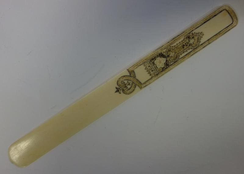 Chinese Ivory Page Turner with Ink Detailing: A Chinese ivory page turner or letter opener. Engraved ink / scrimshaw motif on handle. Measures 9.75" long and 1" wide. NOTE: It is the buyer's responsibility to arrange shipping of ivory to a legal 
