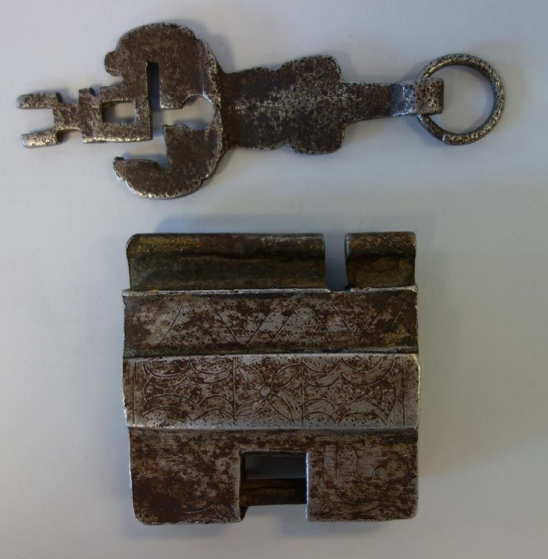 Chinese or Tibetan Cast Iron Lock & Key: A large Chinese or Sino-Tibetan cast iron lock with unique key mechanism. Etched floral and geometric motif. Measures 3.25" x 3-1/8" x 1" thick. The key measures 5" long.