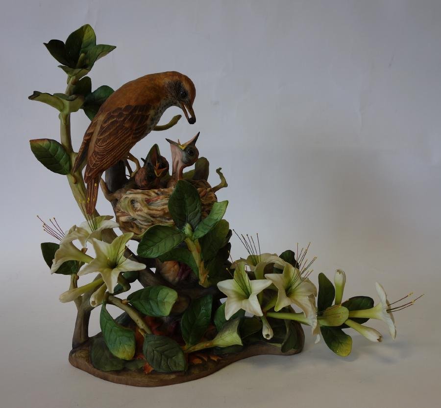 Boehm Limited Edition Sculpture, Wood Thrushes: A porcelain model of wood thrushes. Depicts a mother bird feeding her chicks. Limited edition # 485 by Boehm. Measures 13.5" high, 14" long and 6" wide. Signed on the top of the base and on the unders