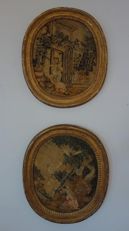 2 Framed English Needlework Pictures: Two wood framed English needlework pictures. One depicting two female figures in front of the doorway to a house. The other depicts a male figure lending a hand to a female as she ascends a ladder. Ea