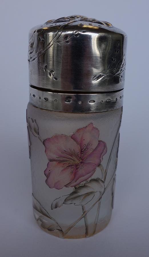 Daum Nancy Cameo Art Glass Perfume Jar: A French art glass perfume bottle or jar. By Daum Nancy, c.1900. Cameo glass depicting flowers which encircle the entire piece. Sterling rim and lid with an embossed flower, leaves and vines. Signed o