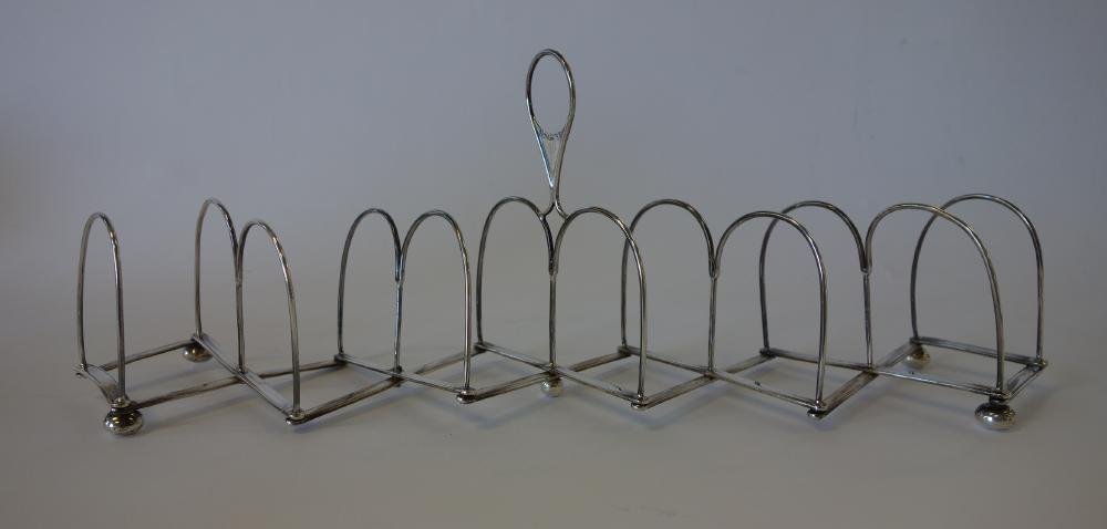 English Sterling Toast Rack, Sheffield 1813: A Georgian sterling expanding / accordion toast rack. 6 holders. Hallmarks for Samuel Roberts Jr. & George Cadman & Co, Sheffield, England, 1813. Crested on one side of the handle with a lion. Measure