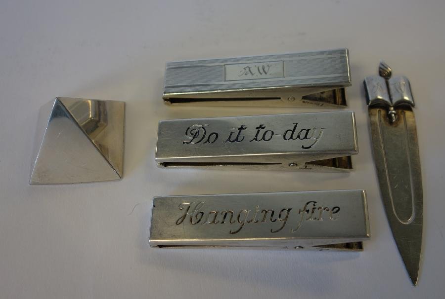 Sterling Desk Objects, Allan Adler Paperweight +: 5 sterling silver desk accessories. Comprised of a pyramid shaped paperweight by Allan Adler measuring 1.5" high, 3 large clothespin type paper clips by the Thomae Company. Measuring 3.25" long. One m