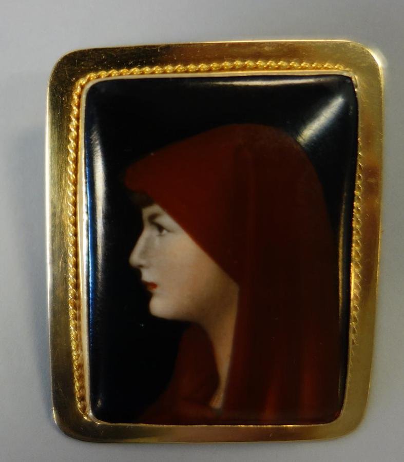 Porcelain Painting of Fabiola in 18K Gold Brooch: A painting on porcelain / plaque set in an 18K gold frame and backed with a pin. The well detailed portrait depicts the profile of a veiled young woman; Fabiola after Jean Jacques Henner. The plaque m