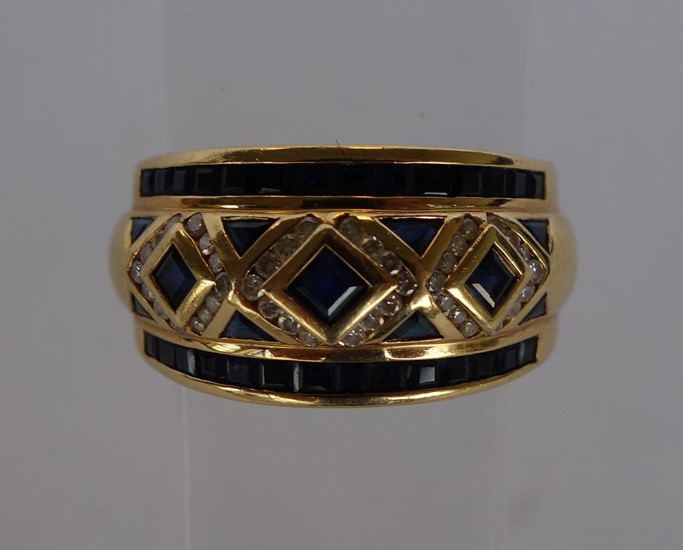 Le Vian Diamond & Sapphire 18K Gold Ring: A LeVian sapphire and diamond ring. The 18K gold ring band set with 28 baguette cut, 8 triangular cut and 3 square cut sapphires, surrounded by 42 diamonds. Stamped 18K, and with maker's mark for Le V