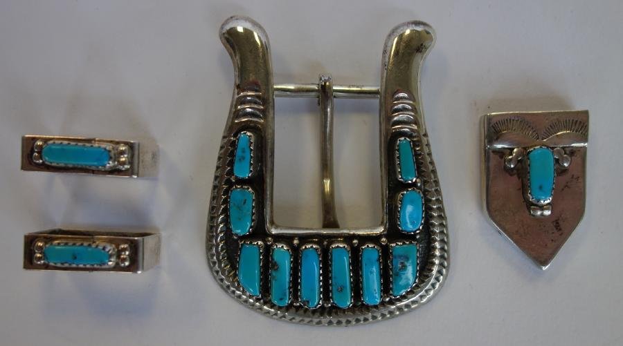 Zuni Turquoise Belt Buckle, Guides & Tip, Leekity: A Zuni turquoise sterling silver belt buckle, signed G & L Leekity, ( George & Lupeta Leekity). Measures 2.25" x 1.75". Together with a sterling / turquoise belt tip and two belt guides.