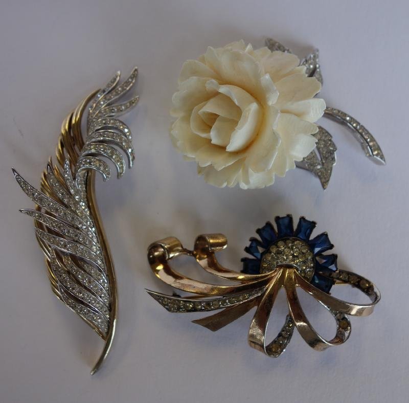 Marcel Boucher, 3 Art Deco Brooch Pins: Three Art Deco brooch pins by Boucher. Comprised of a faux sapphire pin set in sterling and signed with the Marcel Boucher early MB mark. Measures 2.5" wide. Together with a carved ivory rose pin meas
