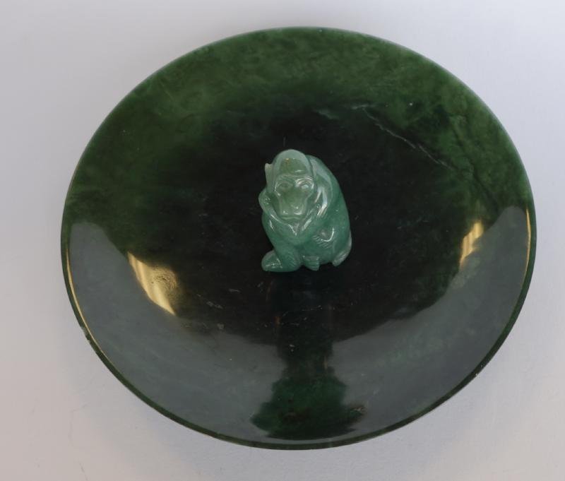 Chinese Spinach Jade Dish & Monkey: A Chinese spinach jade dish / plate. Translucent deep green coloration with darker inclusions. Measures 5-7/8" in diameter and .75" high. Together with a jade monkey measuring 1-7/8" high. CONDITION N