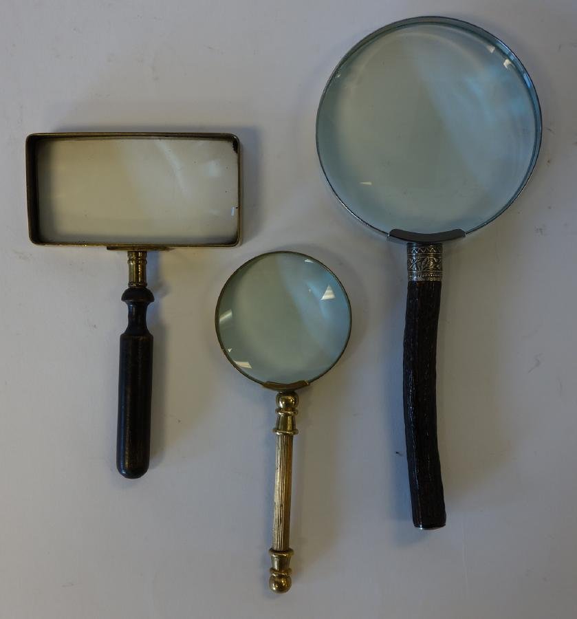 Set of 3 Magnifying Glasses, Vintage: A set of three vintage magnifying glasses. Brass and wood handles. The largest measuring 9.25" long. NOTE: chip to glass on the largest.