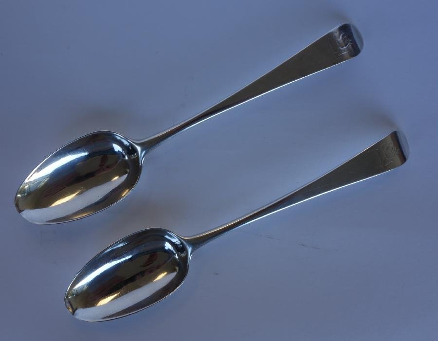 2 English Sterling Tablespoons, London, 1774: A pair of Georgian sterling silver tablespoons. Bottom struck marks. Hallmarks indicating London, 1774, maker's mark I.O. Crested tip depicting a wolf. Initial monogram C on the drop. Each measuring 8