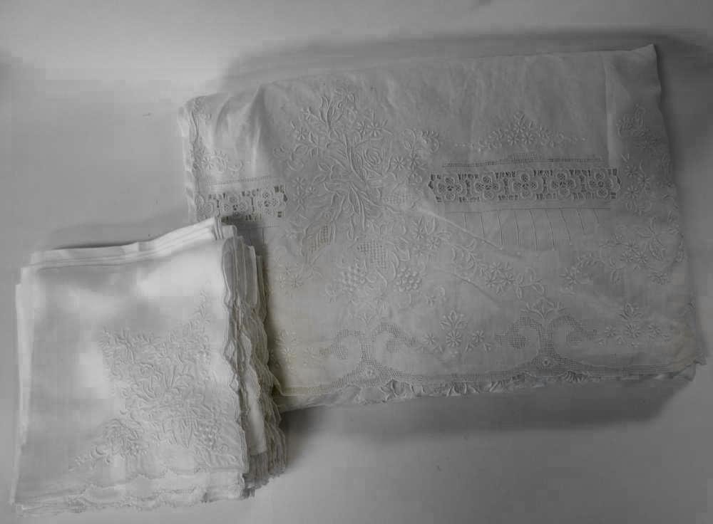 Embroidered Linen Banquet Tablecloth & 35 Napkins: A large embroidered linen and lace banquet tablecloth measuring 20 feet long x 8 feet wide. Together with 35 matching embroidered napkins measuring 23" x 23". The napkins also embroidered Made in Swat