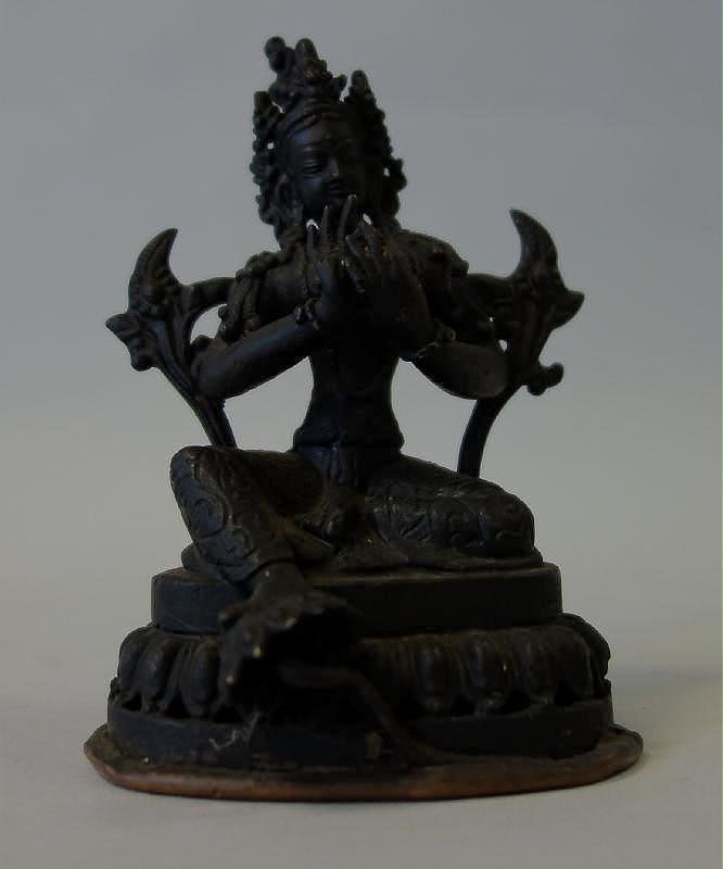 Tibetan Bronze Model of Quan Yin: A small Tibetan or Nepal bronze model of the goddess Quan Yin / Guanyin. The seated figure mounted on a lotus formed base measures 4.75" high