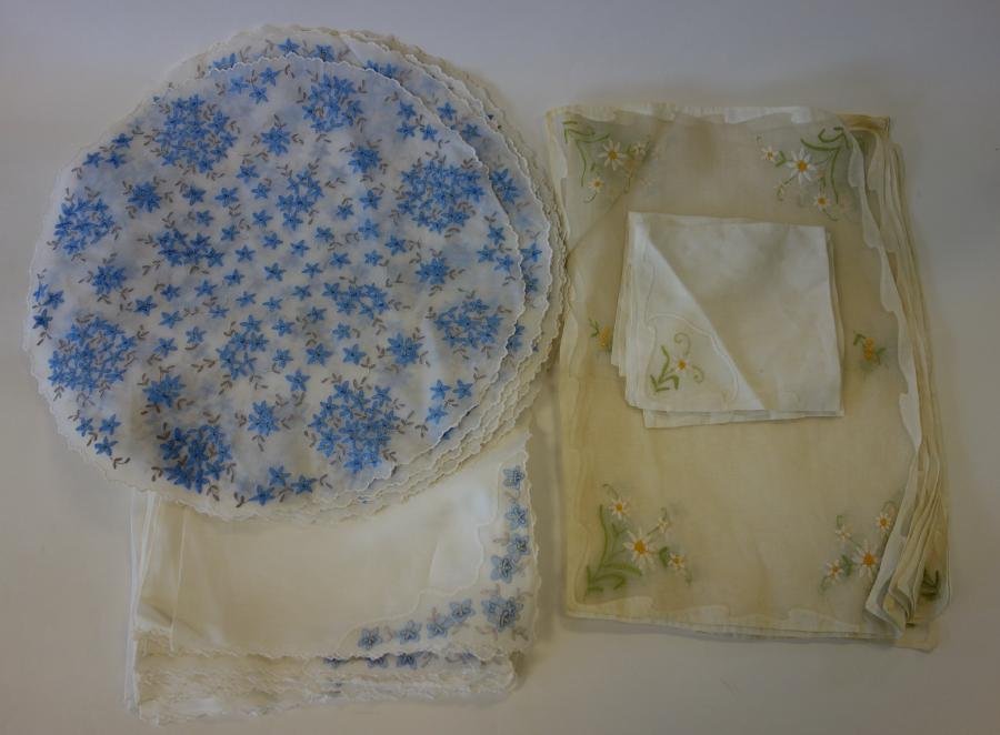 19 Embroidered Linen Place Mats & 16 Napkins: A set of 11 embroidered round linen placemats measuring 16.75" in diameter with 12 matching napkins measuring 21" x 21". Together with a set of 8 embroidered rectangular linen place mats, 18" x 11.5" 
