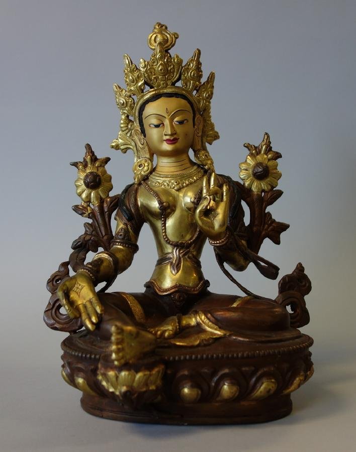 Tibetan Bronze Goddess White Tara: A Buddhist Tibetan bronze figure of White Tara, the goddess of compassion. The gilded bronze seated figure measures 12.5" high and 9" x 6.5" at the base.