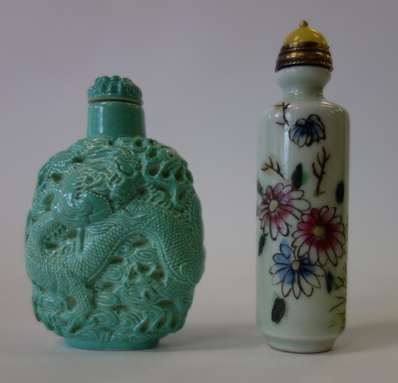 2 Chinese Porcelain Snuff Bottles, Qing Mark: A Chinese molded turquoise porcelain snuff bottle. Decorated with a raised dragon among stylized clouds. Signed underfoot with an apocryphal 4-character Qing Dynasty mark. Measures 2.25" high. Togethe