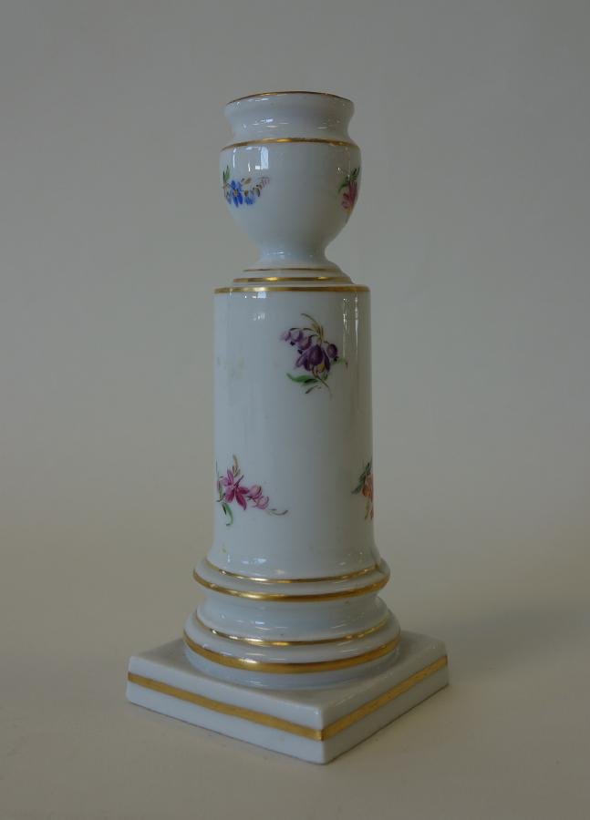 Meissen Porcelain Candlestick: A Meissen porcelain hand-painted candlestick / candleholder. Formed as an urn on a pedestal. Measures 5.75" high. Signed with the cross swords mark underfoot and impressed 139.