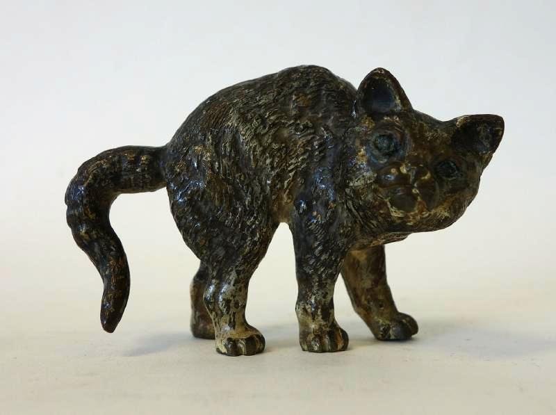 Bronze Arching Cat Sculpture: A bronze model of a cat arching its back. Well detailed. Measures 2.25" high, 3" long, 1.25" wide.