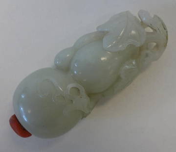 Chinese White Jade Gourd Formed Snuff Bottle: A fine Chinese carved white jade snuff bottle. Qing Dynasty. Well carved and hollowed bottle formed as a double gourd with leaves and vines. Coral stopper. Measures 3.25" long.