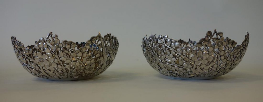 Wang Hing Chinese Export Silver, Bowl Holders: A pair of Chinese silver bowl holders. Embossed cherry blossom motif with branched trees and leaves. 19th / early 20th century. Signed underfoot with the marks for Wang Hing, Hong Kong. Each measuring
