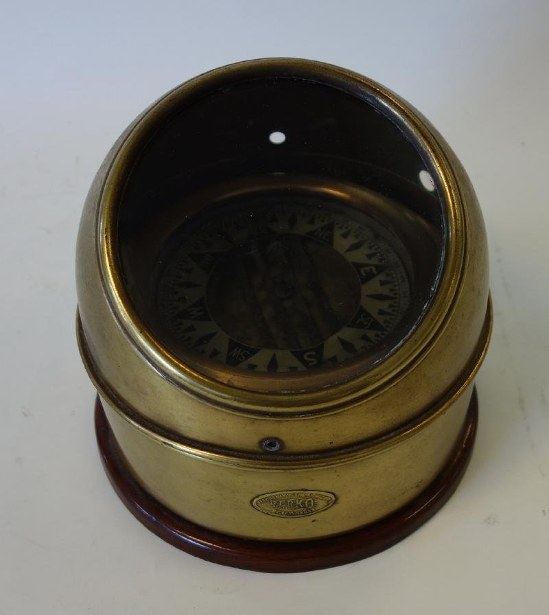 Perkins Perko Binnacle Compass: A binnacle compass by Perkins Marine Lamp Corp, Trademark Perko. Brass case with Maker's plaque. Measures 9" in diameter, 8.75" high.