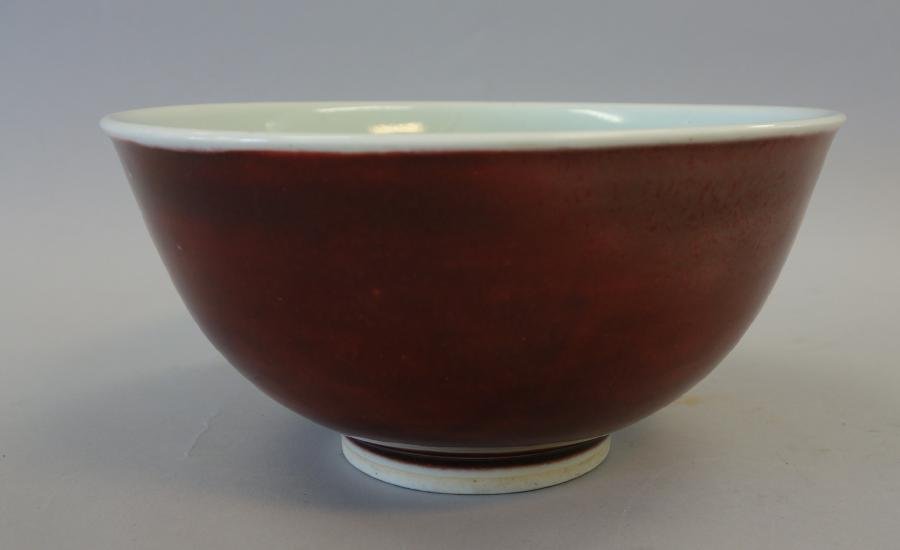 Sang de Boeuf Bowl, Ming Xuande, Nathan Bentz: A Chinese sang de boeuf glazed / oxblood porcelain bowl. Circular footed form with a deep even glaze, bearing a four-character mark in underglaze blue denoting Ming Dynasty, Xuande period. Measures 7"