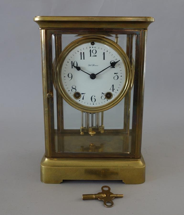 Seth Thomas Regulator Mantel Clock: A Seth Thomas brass and glass regulator mantel clock. Beveled glass sides. With pendulum and key. Measures 9.75" high, 6.5" x 5.5" at the base.