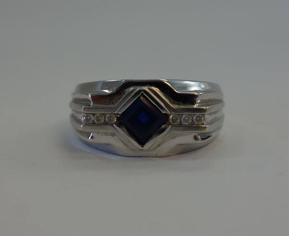 Art Deco Men's Diamond & Sapphire White Gold Ring: An Art Deco 10K gold white gold ring centered with a square cut faceted sapphire, flanked on each side by 3 individual cut diamonds (total of six diamonds). Ring size 10. Overall weight 7.9 grams.