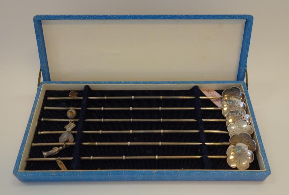 Korean Sterling Straw Spoons with Charms: A set of six Korean Imperial sterling silver straw / stirring spoons / Iced tea spoons. Foliate shaped with etched motif. The handles each with a differing charm. The spoons measure 8.5" long. Overall