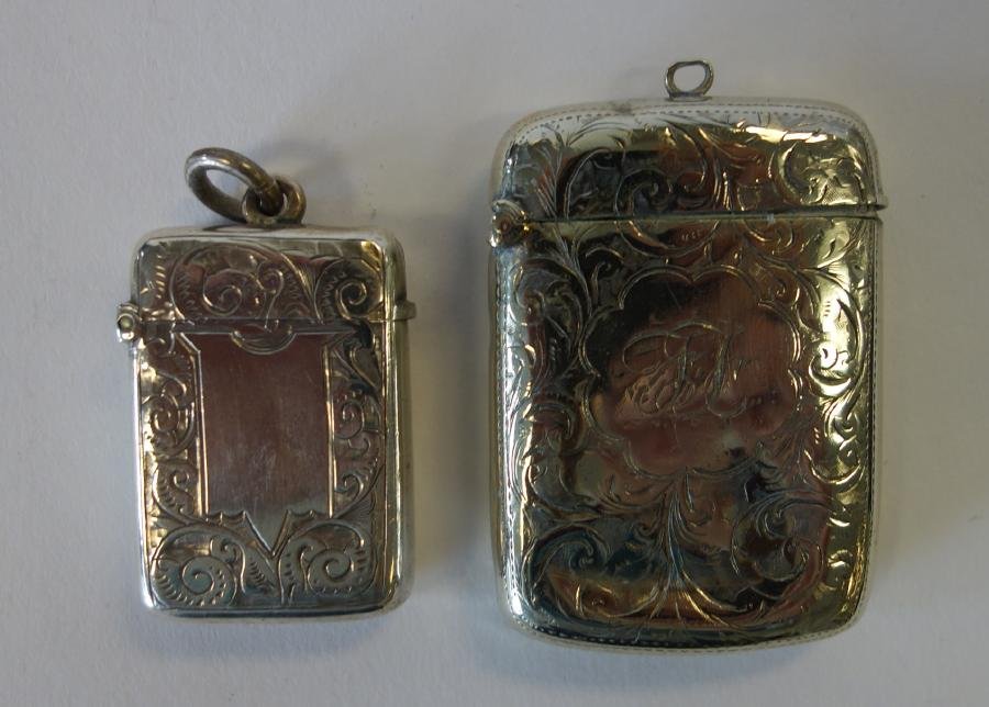 2 Sterling Silver Vesta Cases / Match Safe: A sterling silver vesta, hallmarks for Birmingham, England, 1.75" high. Together with a Continental silver match safe, 2.25" high. Each with chased and etched floral and scroll motif. Overall weight o