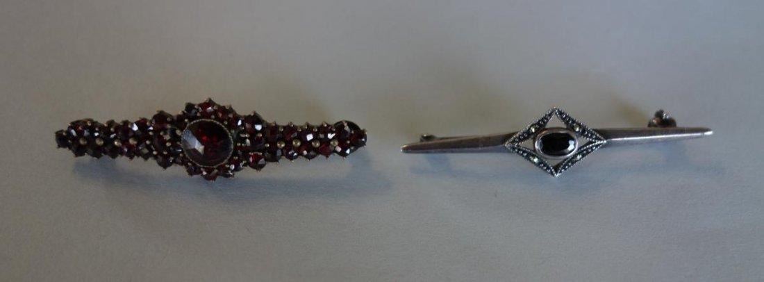 2 Victorian Garnet & Tourmaline Bar Pins: Two Victorian bar pins. A garnet pin marked Czechoslovakia. Together with a sterling and marcasite pin set with a faceted deep green tourmaline. Each measuring 1.75" long.