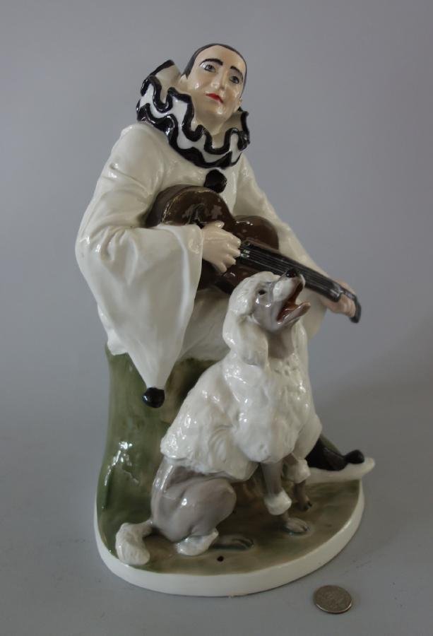 Rosenthal Pierot & Poodle by Rudolf Marcuse: A Rosenthal porcelain figural group depicting Pierot playing a guitar with a poodle at his side. Multi-colored porcelain sculpted by Rudolf Marcuse, 1913. Signed at the back of base and signed with th