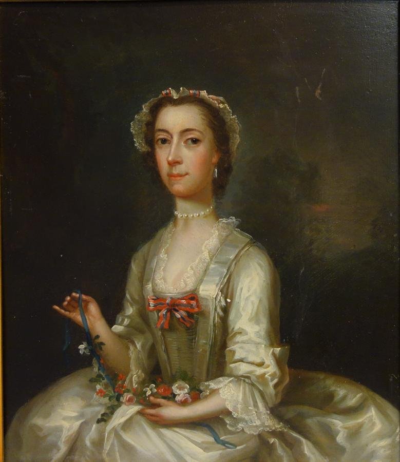 18thc Portrait of a Lady in a White Gown: Framed oil on tin. Late 18th / early 19th century. British School. The painting depicts a young lady in a white silk and lace gown weaving a ribbon through a garland of flowers. Unsigned. Measures 11.