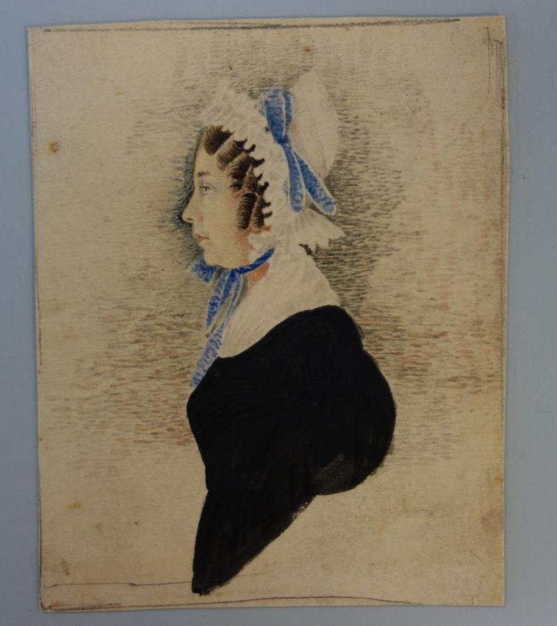 19thc Primitive Portrait of a Lady: A framed miniature naive / primitive portrait of a lady. Early 19th century. Side view depicting a lady in a black dress, white collar and a bonnet tied with blue ribbons. The painting is watercolor o