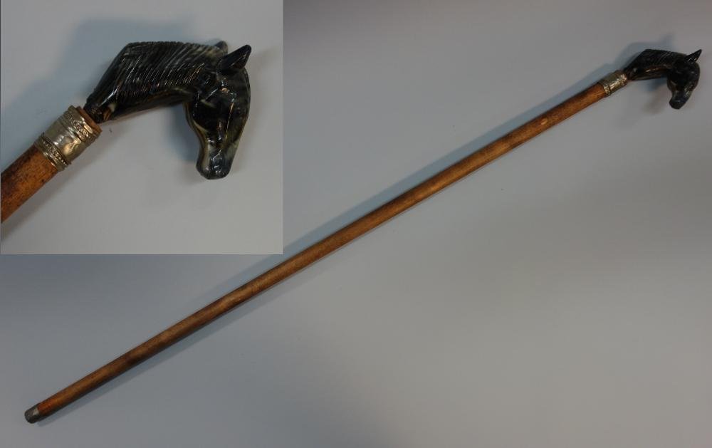 Marbleized Horse Head Handled Cane: A marbleized handled cane / walking stick in the form of a horse's head. Wood shaft, metal wrapped ferrule. Measures 35.5" long.