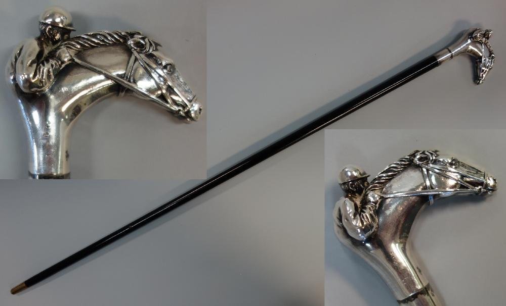 Sterling Handled Horse & Jockey Cane: A sterling handled horse and jockey cane. The sterling silver handle in the form of race horse's head and jockey, marked "925" within an oval, indistinct maker's mark, a star and ..? within a rectangl