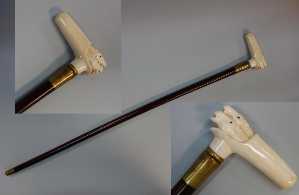 Antique Walrus Ivory Racing Horse Handled Cane: An antique carved walrus ivory handled cane / walking stick. c.1900. The handle in the form of three racing horses with black glass eyes. Wood shaft, brass collar and ferrule. Measures 36.75" long, th