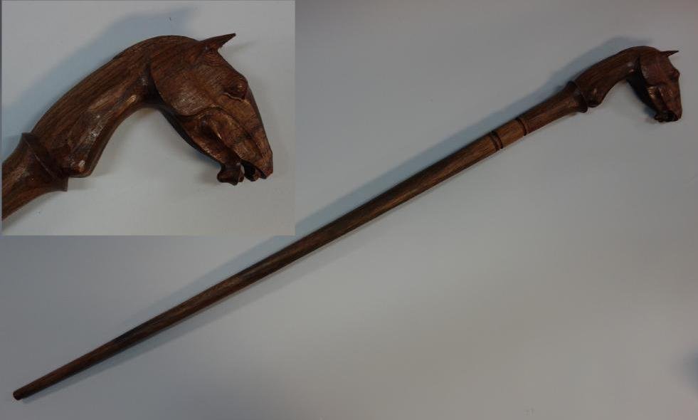 Carved Wood, Horse Head Handled Cane: A carved wooden handled cane / walking stick in the form of a horse's head. Wood shaft. Measures 36.76" long.