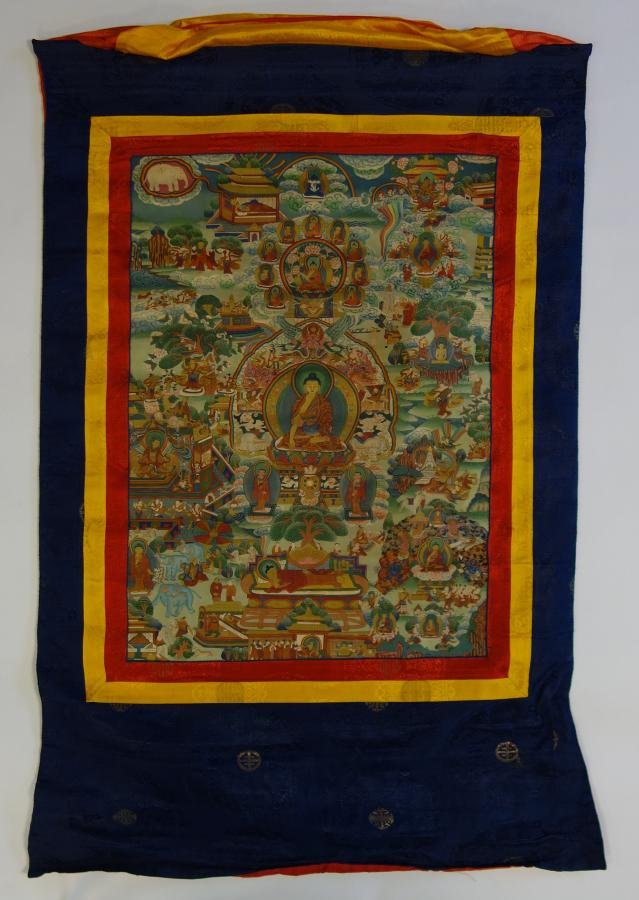 Tibetan Thangka Painting, Shakyamuni Buddha: A Tibetan Thangka painting on silk. Depicts Shakyamuni Buddha surrounded by visions of nirvana, elephants, foo lions and other animals and mythological beasts plus female shakti / consorts. Well paint