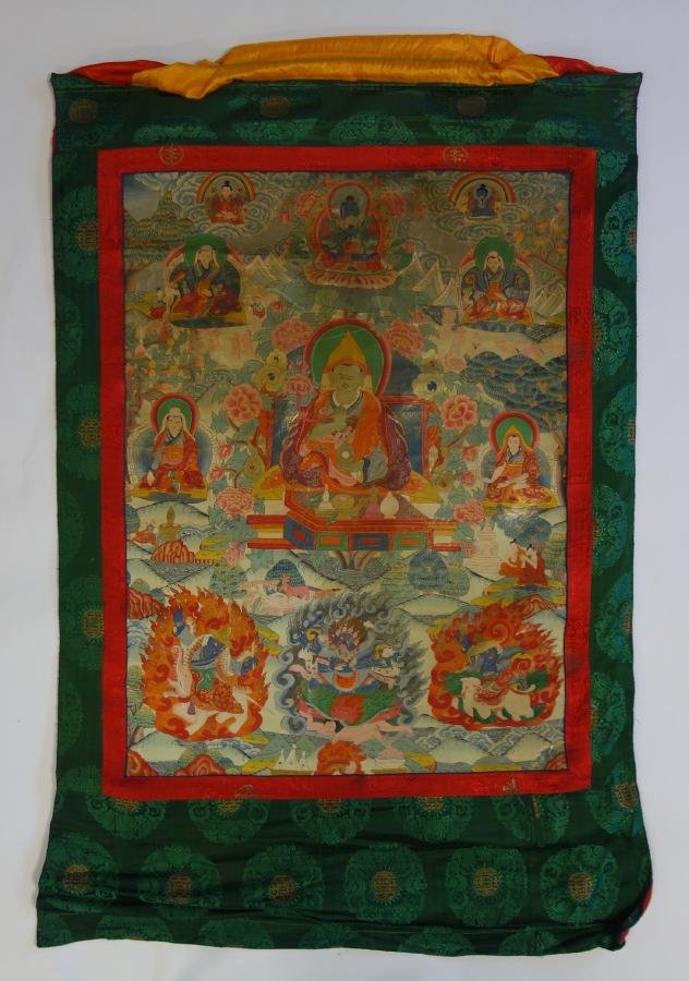 Tibetan Thangka Painting, Buddha & Consorts: A Tibetan Thangka painting on silk. Depicts Buddha with a moustache, surrounded by elephants, foo lions and other aniimals and mythological beasts plus female shakti / consorts. Well painted and detai