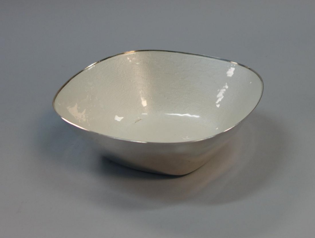 J. Tostrup, Norway, Sterling & Enamel Bowl: A Norwegian sterling and white enamel bowl by J. Tostrup, Norway. Marked on the underside with the maker's name, cipher, and Sterling. Measures 5-7/8" x 5-7/8" x 2" high. Weighs 8.5 troy oz. CONDITION
