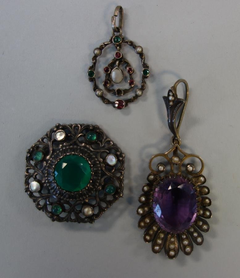 Amethyst & Tourmaline Pendants & Brooch: An Edwardian amethyst pendant surrounded by seed pearls, set in a gilt metal flower-formed surround. Measures 2-3/8" long from pendant bail. Together with a pink and green tourmaline pendant with moth