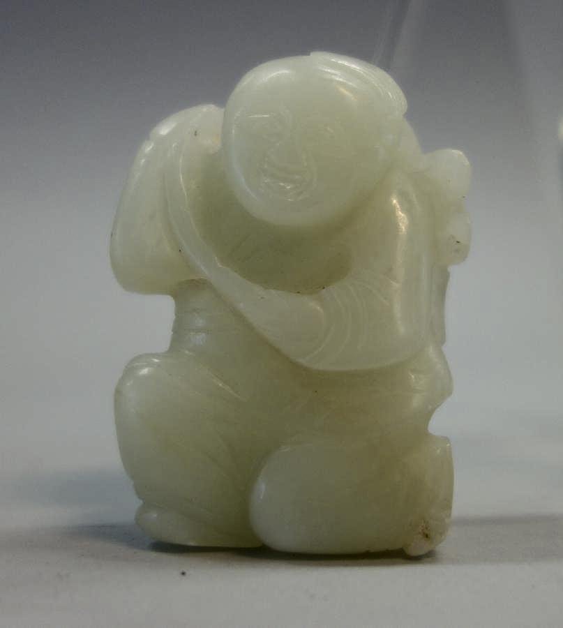 Chinese White Jade Carving: A Chinese white jade carving. Depicts a boy carrying a leafy branch. Measures 2-1/8" high, 1.5" wide, .75" deep.