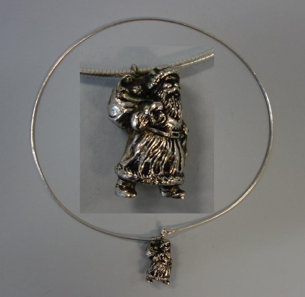 Santa Pendant & Sterling Necklace: A "Santa" pendant attached to a sterling silver necklace measuring 17-7/8" long. The silvered pewter Santa Claus measures 1" high and is marked HMK 1991.
